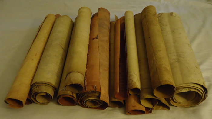 a pile of Torah scrolls
